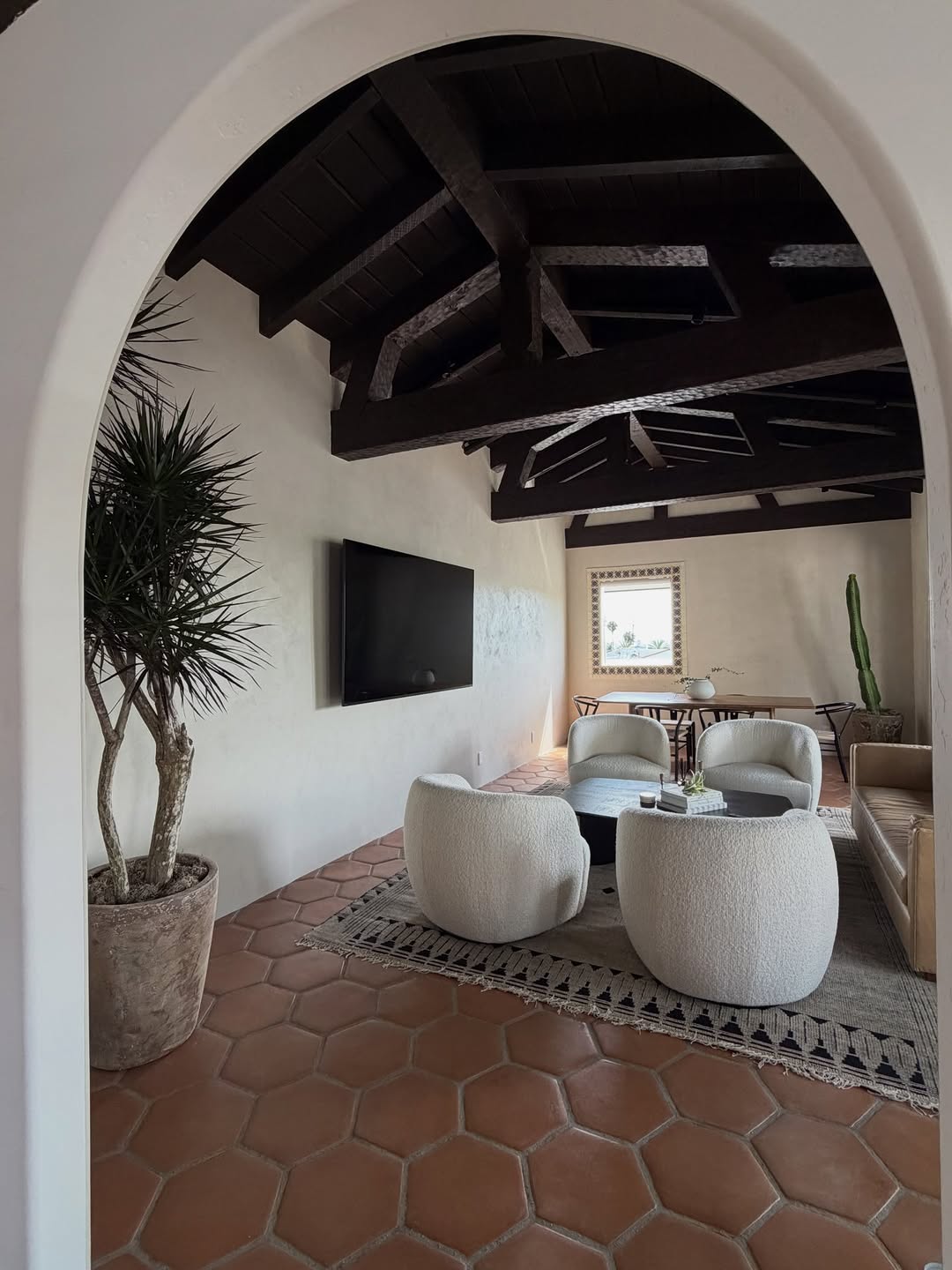 Saltillo hex tile floor in an arched Spanish style living room