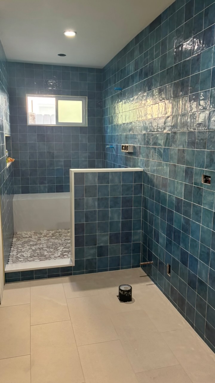 Blue ceramic tile shower installation