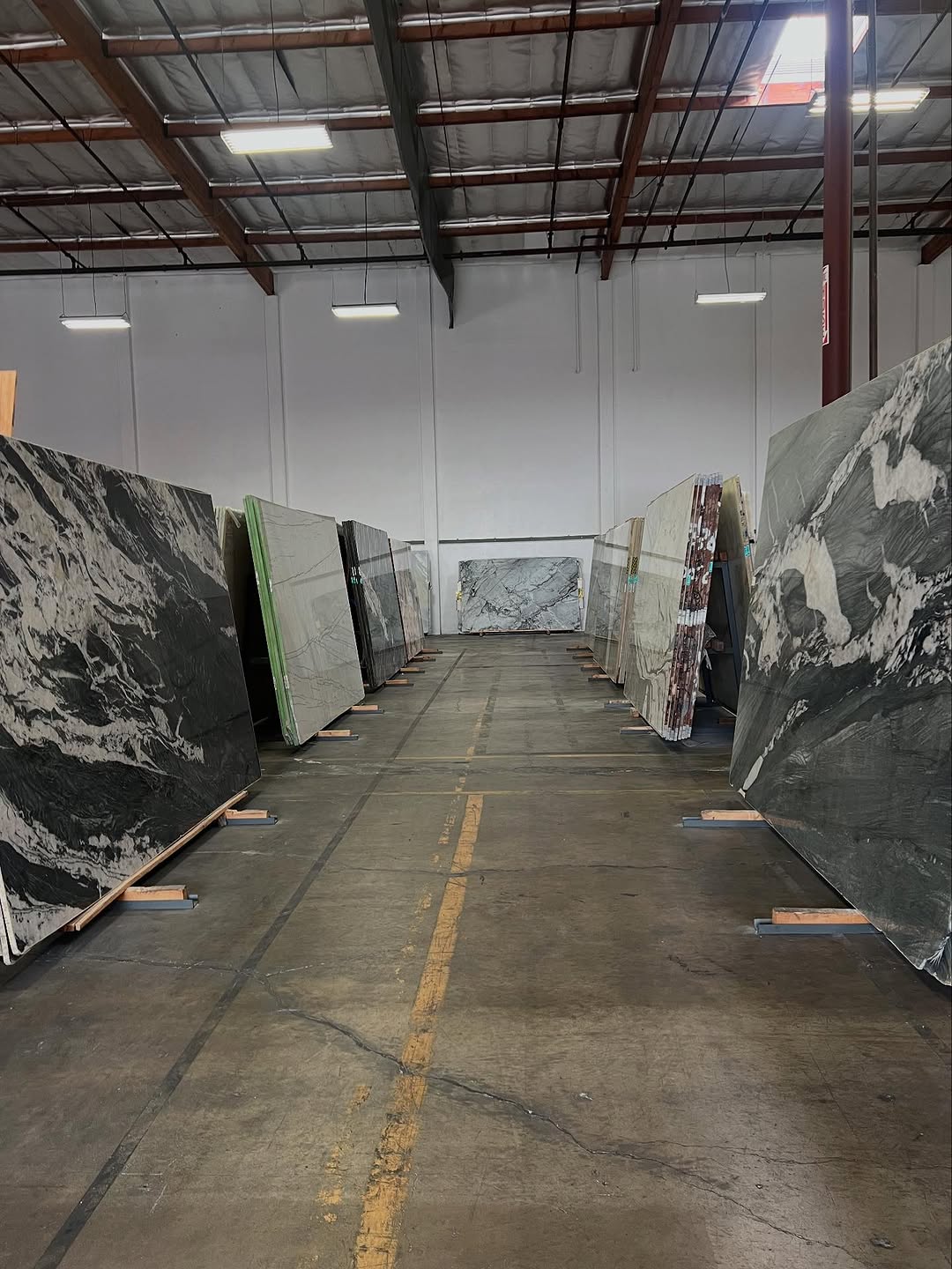 Rows of natural stone slabs in the showroom aisle
