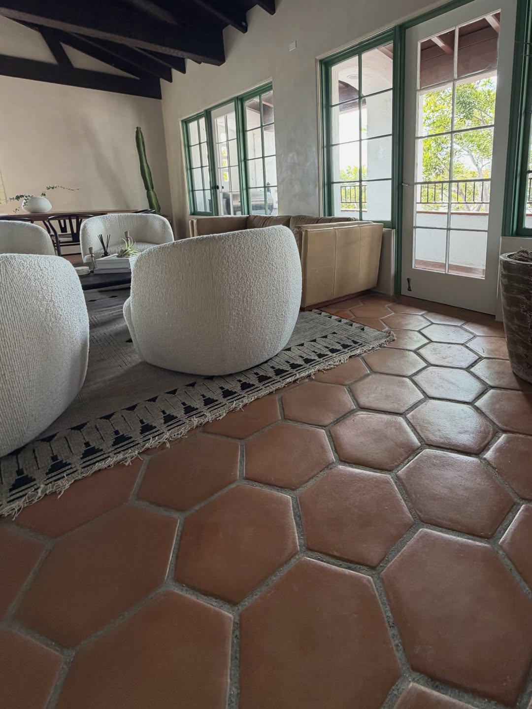 Terracotta hex tile floor in a beamed living room
