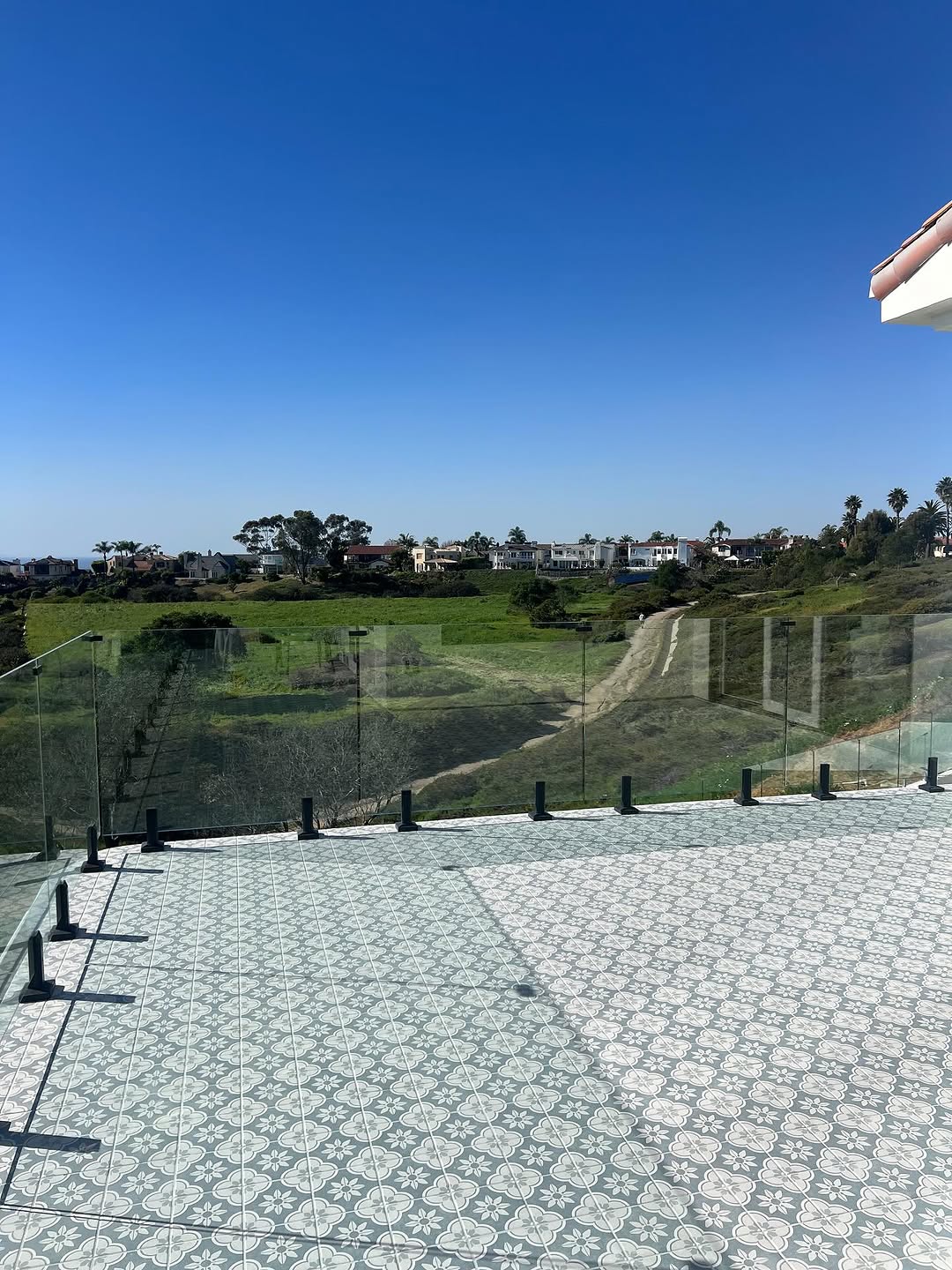 Patterned tile terrace with a hillside view